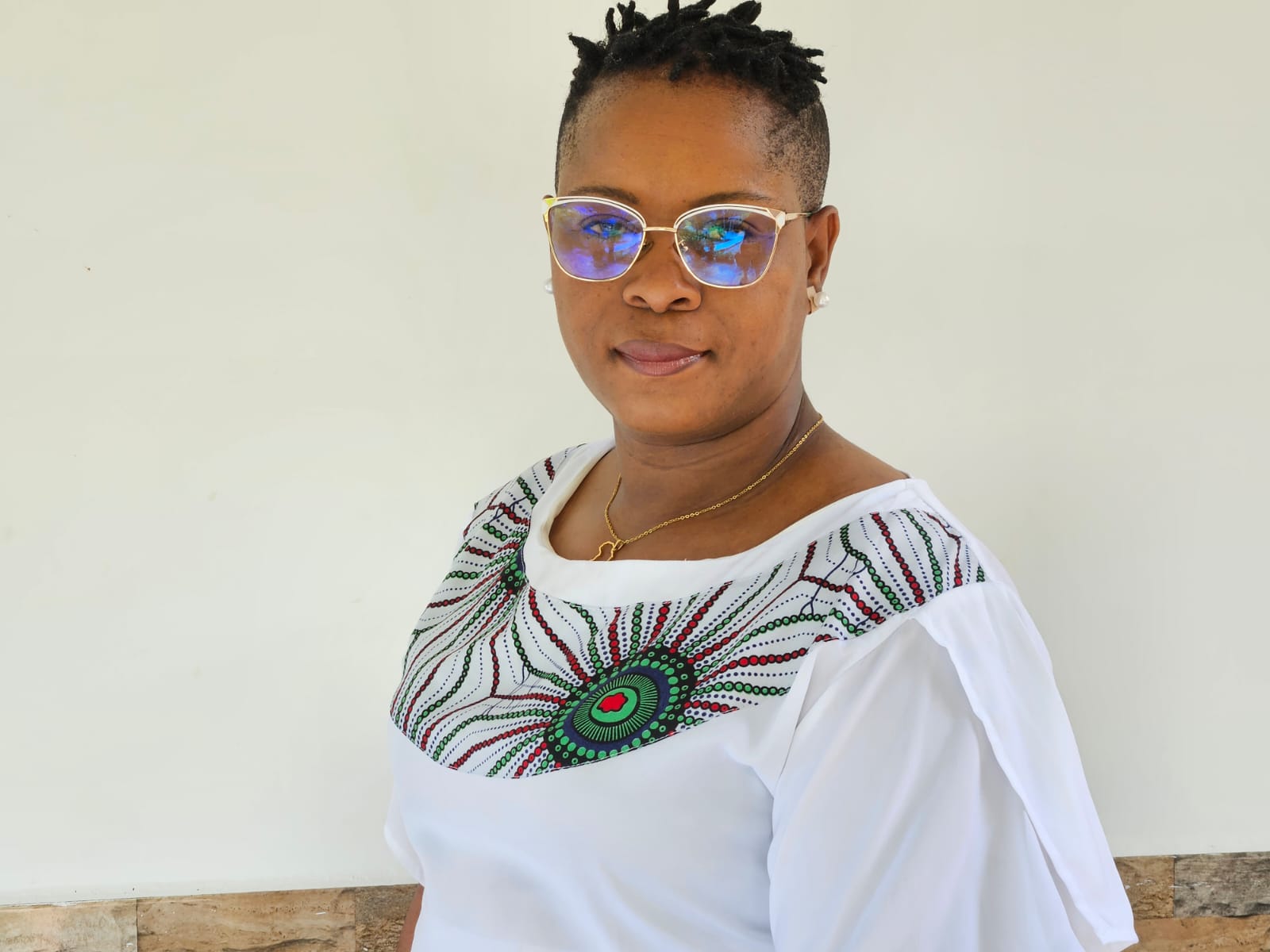 woman in white blouse with colorful neckline