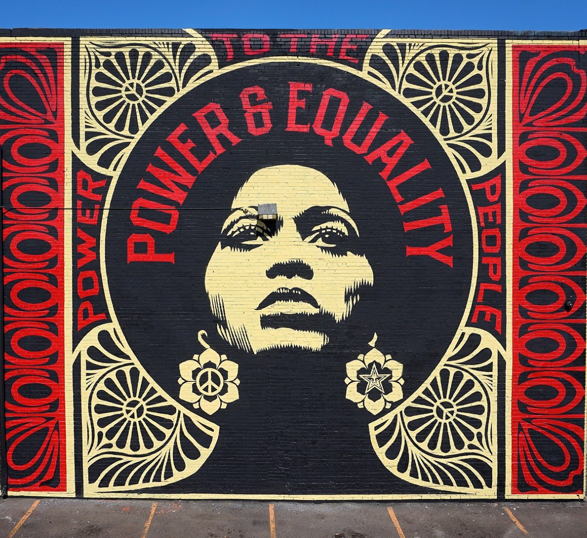 red and black mural depicting a Black woman with the words Power and Equality Art by Shepard Fairey